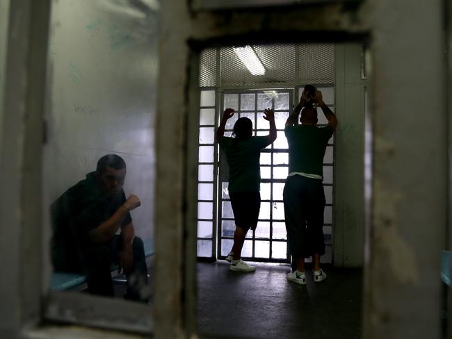 Prisoners wait in a holding cell while in the process of being transfered for a court appearance or to another jail. Picture: Adam Taylor