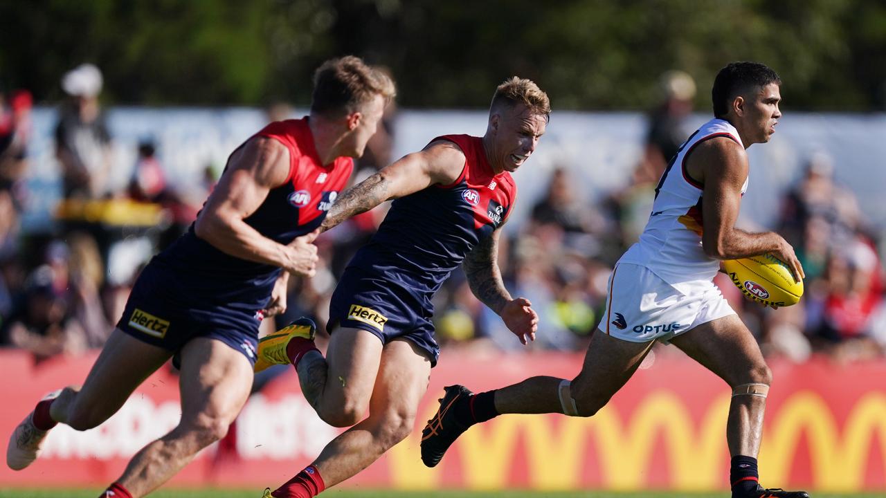 Tyson Stengle of the Crows runs with the ball from James Harmes of the Demons during the AFL Marsh Community Series pre-season match between the Melbourne Demons and Adelaide Crows at Casey Fields in Melbourne, Saturday, February 22, 2020. (AAP Image/Michael Dodge) NO ARCHIVING, EDITORIAL USE ONLY