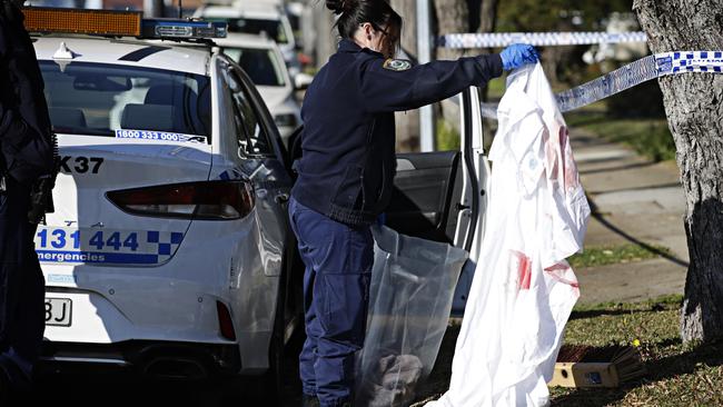 Police bagging evidence at the crime scene at Wall Ave in Panania. Picture: Adam Yip