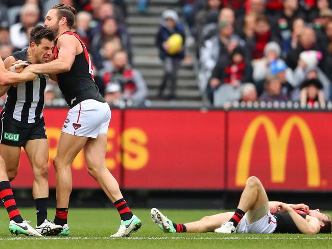 Angry Bombers wrestle with Levi Greenwood after his high hit on Zach Merrett. Picture: Getty Images