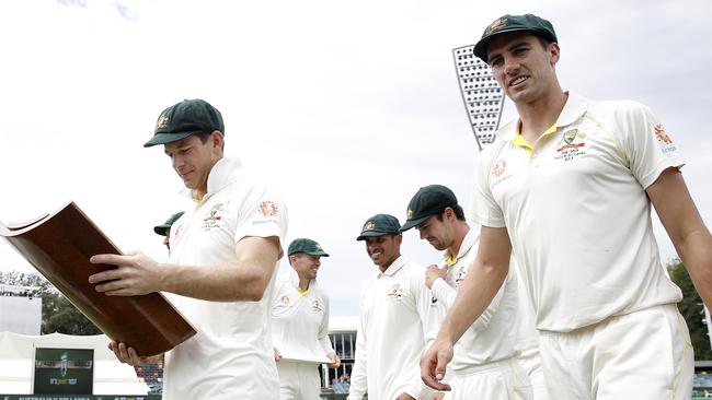 Tim Paine (left) checks out the series trophy with man of the series Pat Cummins (right). Picture: Getty Images