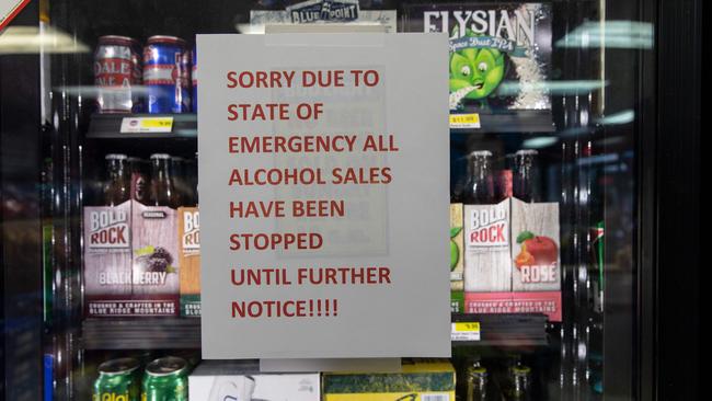 A sign warning customers that alcohol sales are suspended due to a “state of emergency” at an Exxon station in Harbinger, North Carolina. More than one million people in North Carolina, South Carolina and Virginia have been told to flee their homes as the hurricane approaches. Picture: Alex Edelman/AFP