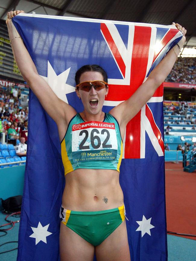 Jana Pittman holding Aussie flag after winning women's 400m hurdles final race at 2002 Commonwealth Games in Manchester.