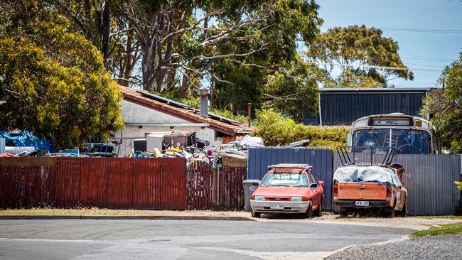 Cars and a bus are among the rubbish at the Aldinga Beach home.