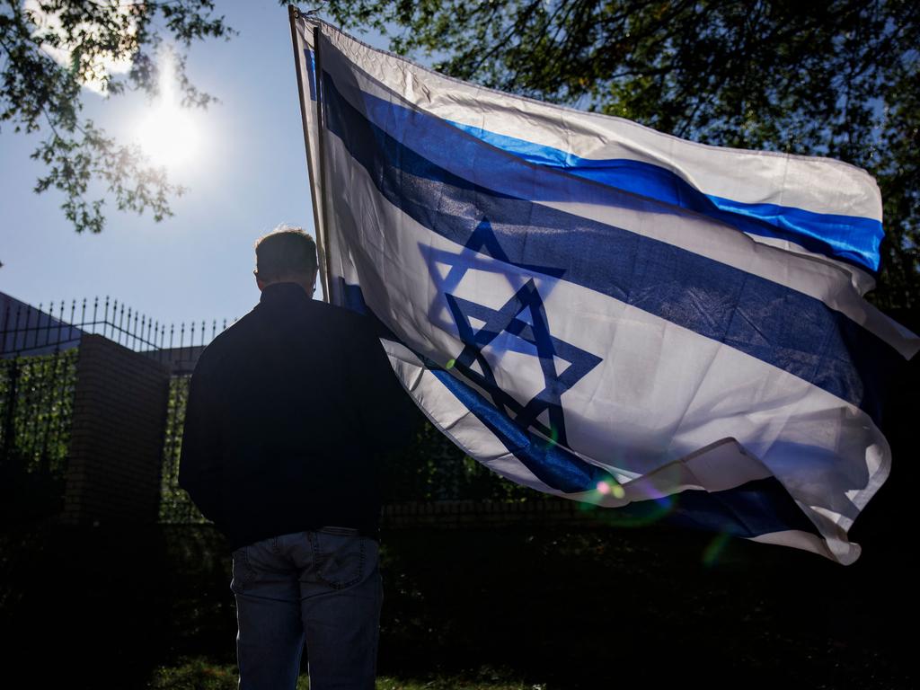 A man carries two Israeli flags during a pro-Israel rally outside of Israeli Embassy on October 8, 2023 in Washington, DC, after the Hamas attack. Picture: Samuel Corum/Getty Images North America/AFP