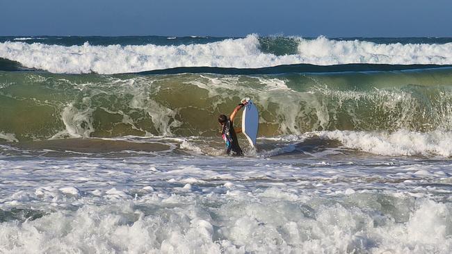 Conditions were super messy and dangerous at Mooloolaba Spit. The beach was closed but that did not stop plenty from entering the water. Photo: Mark Furler