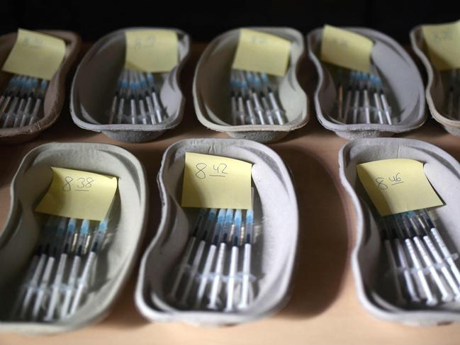 (FILES) In this file photo taken on May 19, 2021 trays with syringes filled with the AstraZeneca vaccine against COVID-19 lay ready for use at the St Antonius Church in Castrop-Rauxel, western Germany. - More than half the population of Germany is now fully vaccinated, the German Health Minister Jens Spahn said on July 27, 2021, hailing "another milestone" in Europe's biggest economy's inoculation drive. (Photo by Ina FASSBENDER / AFP)