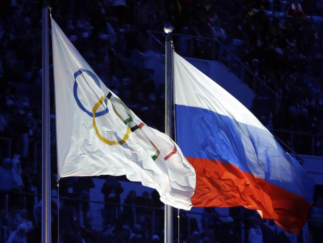 The Russian and the Olympic flags wave during the opening ceremony of the 2014 Winter Olympics in Sochi, Russia. Picture: AP