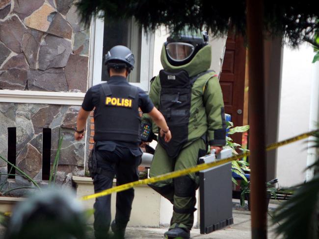 Indonesian antibomb squad carry an explosive from the Santo Yosef church after a man tried to attack a priest in Medan on August 28, 2016. Picture: AFP.