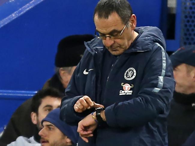 Chelsea's Italian head coach Maurizio Sarri checks his watch on the touchline during the English FA Cup fifth round football match between Chelsea and Manchester United at Stamford Bridge in London on February 18, 2019. (Photo by Ian KINGTON / AFP) / RESTRICTED TO EDITORIAL USE. No use with unauthorized audio, video, data, fixture lists, club/league logos or 'live' services. Online in-match use limited to 120 images. An additional 40 images may be used in extra time. No video emulation. Social media in-match use limited to 120 images. An additional 40 images may be used in extra time. No use in betting publications, games or single club/league/player publications. /
