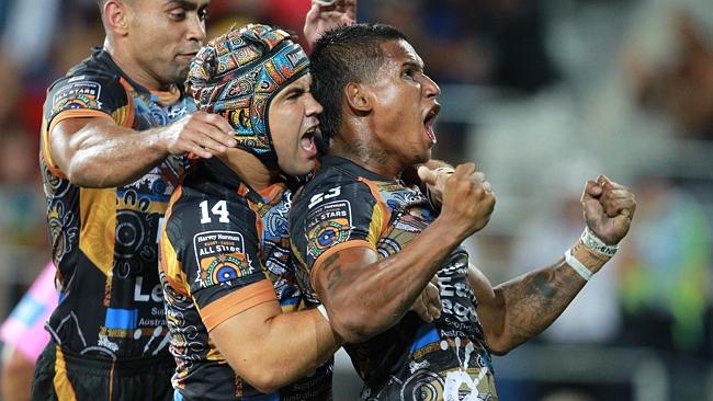 Ben Barba (right) of the Indigenous All Stars celebrates scoring a try with Jamie Soward.