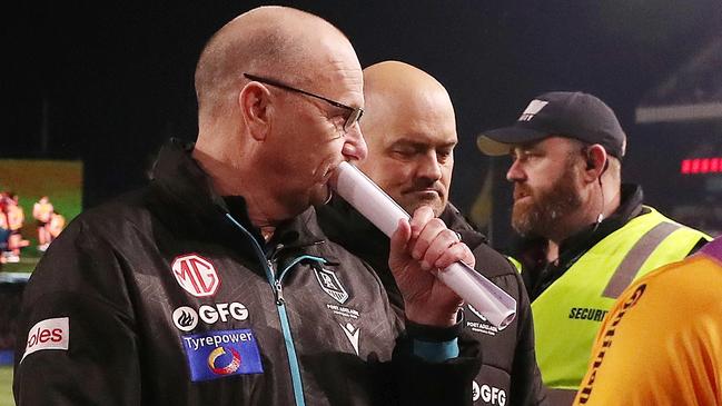 Ken Hinkley and Chris Davies on Saturday night. Picture: Sarah Reed/AFL Photos