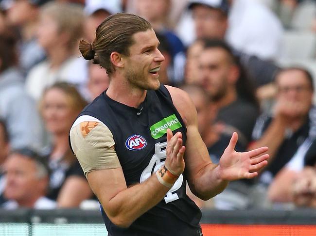 MELBOURNE, AUSTRALIA - MAY 07: Bryce Gibbs of the Blues celebrates after kicking a goal in front of magpies supporters in the crowd during the round seven AFL match between the Collingwood Magpies and the Carlton Blues at Melbourne Cricket Ground on May 7, 2016 in Melbourne, Australia. (Photo by Scott Barbour/Getty Images)