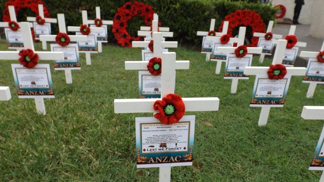 Logan historian Mic Noble made dozens of white crosses to remember the men and women from Logan who served for their country. Sadly, some of their graves remain without headstones. Picture: Richard Walker 2021