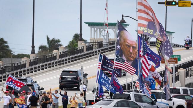 People watch as the motorcade carrying President-elect Donald Trump's leaves Mar-a-Lago resort on November 19, 2024 in Palm Beach, Florida. Picture: AFP