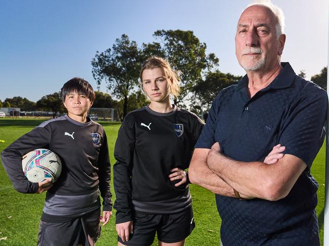 WNPL players, Yuka Sasaki and Izabel Czechowicz, with president, Jim Tsouvalas from the Adelaide Comets Football Club, where Adelaide City Council have knocked back a request for a 1.1m fence to be built, Wednesday, Feb. 14, 2024. Picture: Matt Loxton