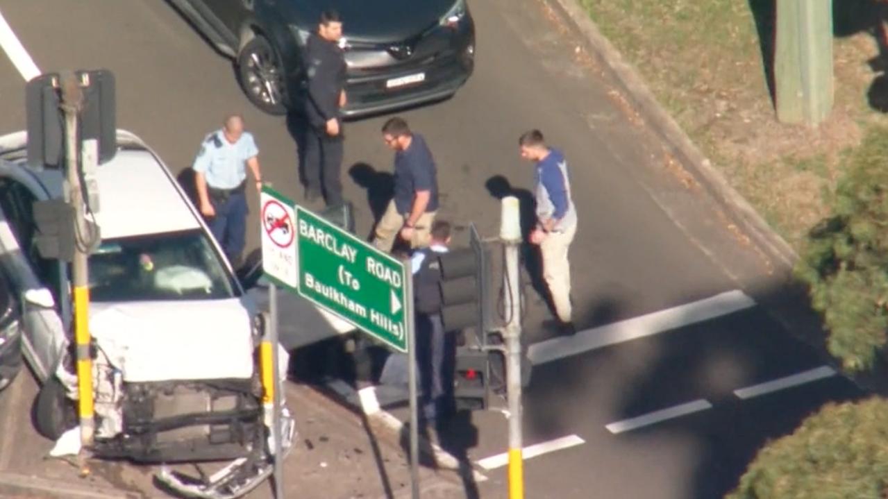 A man was handcuffed up against a light pole after the crash. Picture Nine News