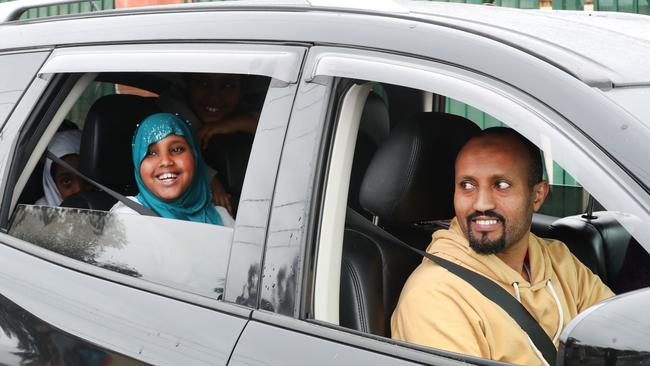 Mr Adam and his family leave the drive through COVID testing site. Picture: David Crosling