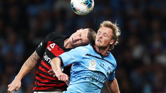 Wanderers striker Mitchell Duke (left) and Sydney FC defender Rhyan Grant compete for the ball.