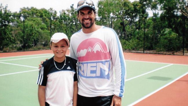 A young Ash Barty with Pat Rafter.