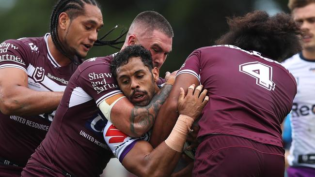 Melbourne's Josh Addo-Carr is wrapped up by the Sea Eagles defence. Picture: Brett Costello