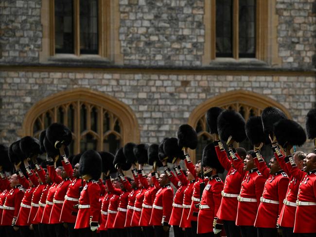 Soldiers from the Irish Guards remove their busbees to honour King Charles III during a ceremony where he presented New Colours to No 9 and No 12 Company. Picture: AFP