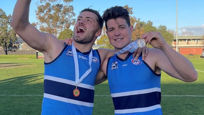 Mitch Palma and Luke Henderson celebrate the flag.