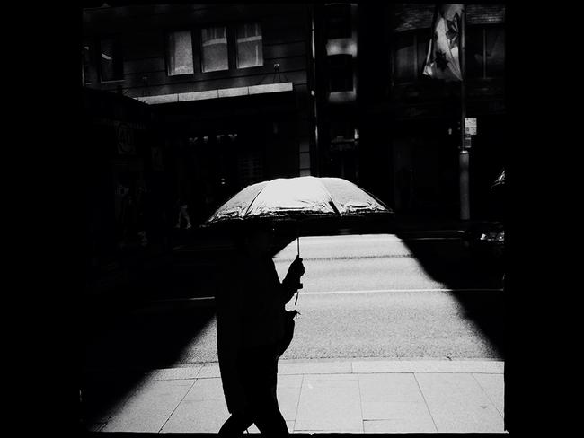 Markus Andersen's 'Protection': Shot on a hot Sydney day in the CBD where many people were using umbrellas for protection. I observed a blinding patch of sunlight breaking through the canyon of skyscrapers and captured a pedestrian beside me with a dark umbrella. Picture: Head On Head On Photo Festival Mobile Prize 2014