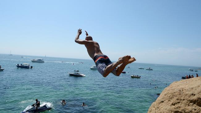 A man jumps off the Pillars cliff at Mount Martha. Picture: Lawrence Pinder