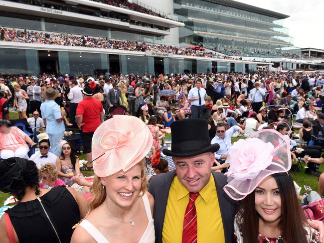 Racegoers Anu Konkola, Bruce Dawson and Malinee Khao at the 2014 Melbourne Cup. Picture: Jason Sammon