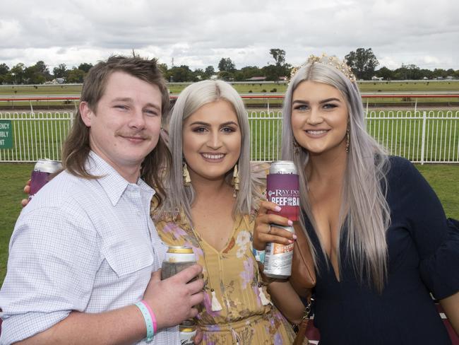 Sam Kempnich and his mullet, with Makaela and Sophie Landenberger at South Grafton Cup Day in 2019.