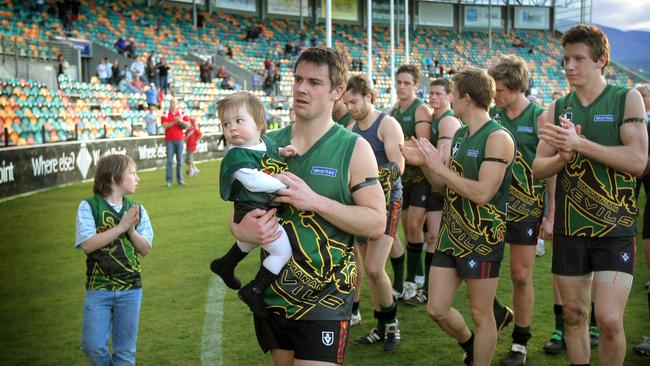 Football last VFL game for the Tasmanian Devils team, Tasmanian Devils versus Box Hill Hawks at Bellerive Oval, skipper Brett Geappen leads the team off carrying one year old daughter, Penelope