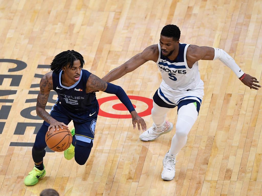 Malik Beasley of the Minnesota Timberwolves defends against Ja Morant of the Memphis Grizzlies.