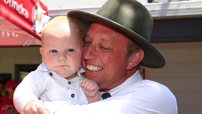 Queensland Premier Steven Miles visits pre-polling at the Caloundra Cricket Club on the Sunshine Coast where he cuddles six-month-old Seamus Fouhy. Picture: Adam Head