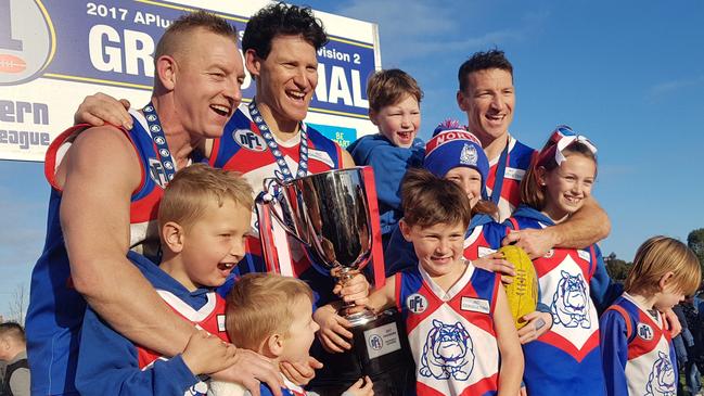 Blair, Shane and Brent Harvey celebrate North Heidelberg's 2017 premiership. Picture: Tim Michell.