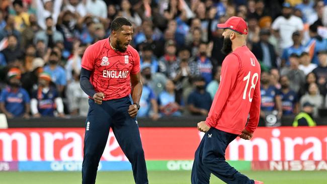 England's Chris Jordan (L) celebrates a wicket against India.