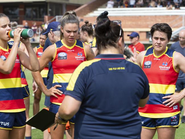 Courtney Gum, right, stands with Danielle Ponter, left, and Anne Hatchard as they listen to assistant coach Narelle Smith during the trial game against GWS at Richmond Oval. Picture: AAP/Emma Brasier