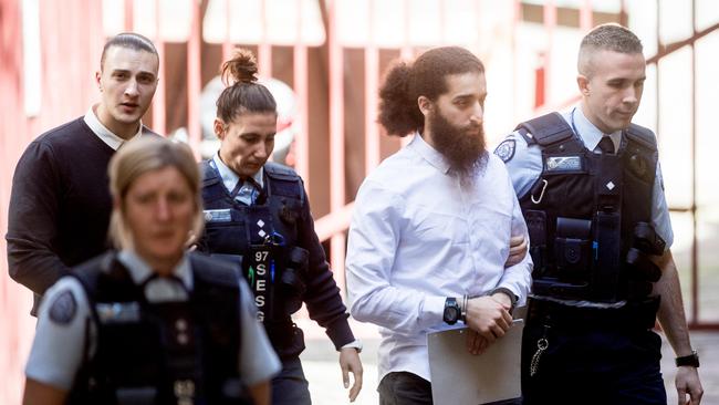 Mohamed and Chaarani are led into court. Picture: Jake Nowakowski