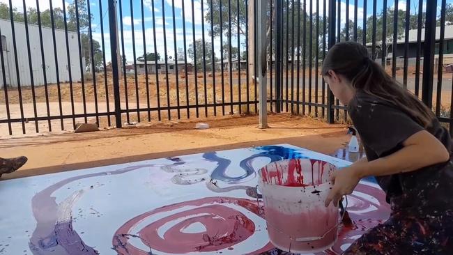 Stills taken from a video in which a non-indigenous employee – Tjala Art manager Rosie Palmer – is seen contributing to a painting by (Indigenous) artist Yaritji Young.