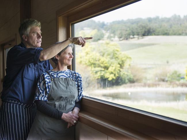 Evans and partner Sadie Chrestman look out over the fertile fields of their Glaziers Bay property. Picture: Alan Benson