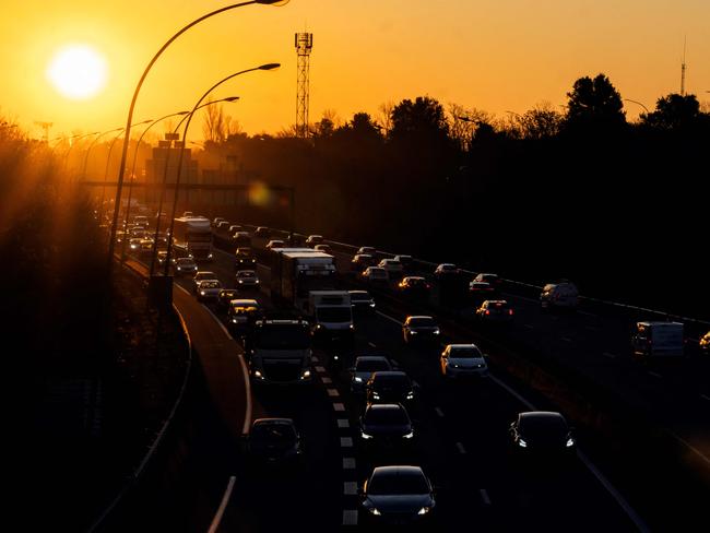 This photograph shows cars in a heavy traffic as the sun rise on the road ring (peripherique) in Toulouse, southwestern France on February 6, 2025. (Photo by Lionel BONAVENTURE / AFP)