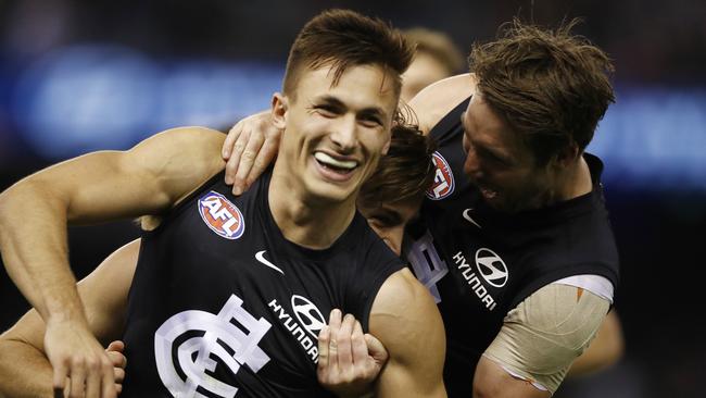 Josh Deluca is mobbed by teammates after booting his first goal in navy blue. Pic: AAP