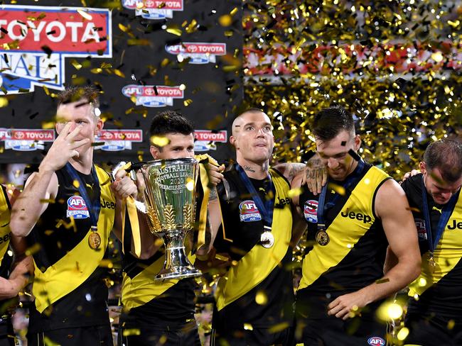 BRISBANE, AUSTRALIA - OCTOBER 24: Dustin Martin of the Tigers and team mates celebrate victory after the 2020 AFL Grand Final match between the Richmond Tigers and the Geelong Cats at The Gabba on October 24, 2020 in Brisbane, Australia. (Photo by Bradley Kanaris/AFL Photos/via Getty Images)