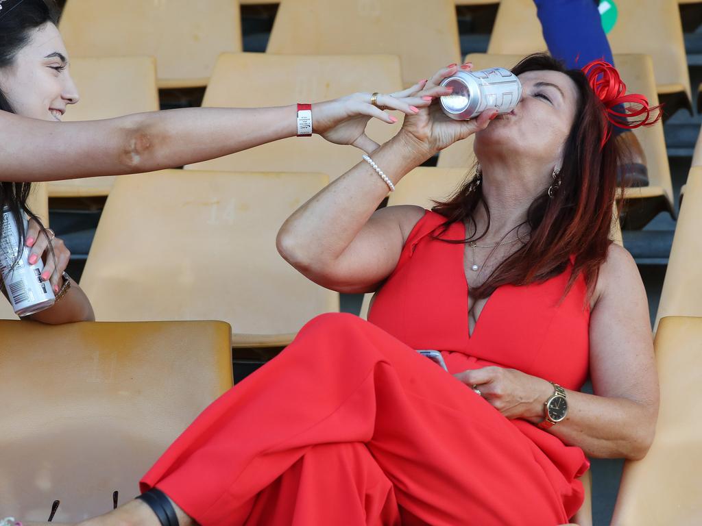 Keeping hydrated at Melbourne Cup Day celebrations in Doomben, Queensland. Photographer: Liam Kidston