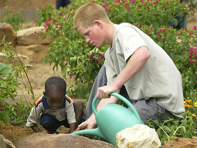 Nineteen-year-old Prince Harry and Mutsu Potsane, 4, plant a fruit tree at the Mants'ase Children's Home near Mohale's Hoek, Lesotho. Picture: AP