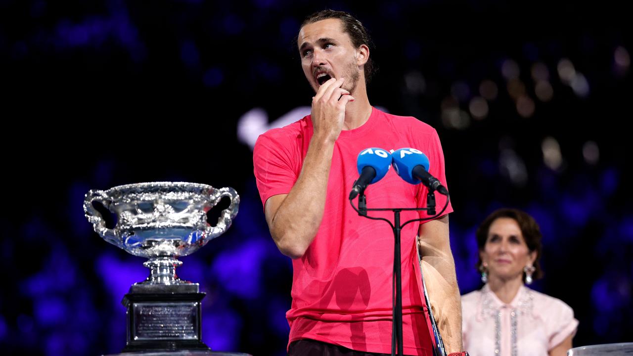 Alexander Zverev pauses his speech while the protest rings out. (Photo by Martin KEEP / AFP)