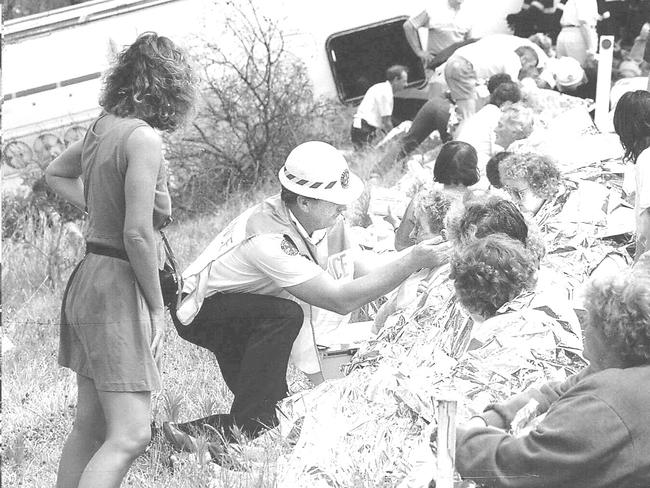 Emergency services helping victims of the Wide Bay Tour bus incident on October 24, 1994.