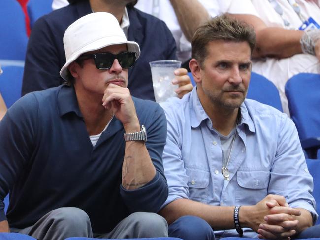 Actors Brad Pitt, left, and Bradley Cooper watch the match.