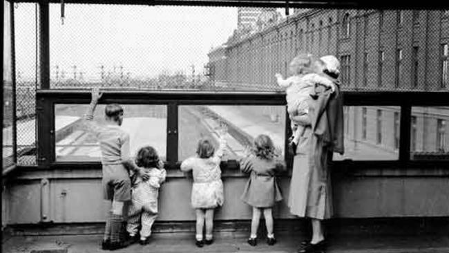 Children looking out from the creche at Flinders Street Station in the 1930s. Picture: PROV.