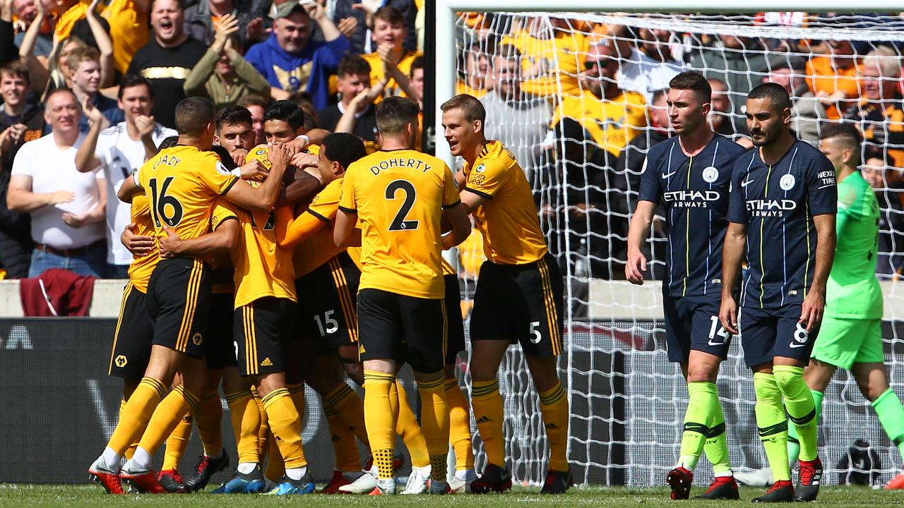 Wolverhampton Wanderers' French defender Willy Boly (C) celebrates with team-mates after scoring the opening goal